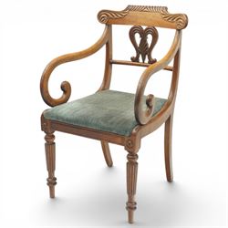 Set of eight (6+2) Regency period mahogany dining chairs, the ornately carved cresting rail of gadrooned and foliate design, over a pierced swan-neck splat with scrolling foliate carving, the carvers with scrolled arm terminals, over teal-upholstered drop-in seats, raised on Gillows-design reeded and tapering front supports, retailed by David Hick Interiors, Jersey