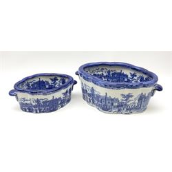 Two Victoria Ware blue and white footbaths, each with twin lug handles and transfer print decorated with city scape, each with printed mark beneath, largest not including handles L34cm, smaller not including handles L25cm.