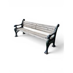 Neoclassical design cast iron and oak slatted garden bench, the twin end supports in the form of a Sphinx with acanthus carved knees and large paw feet, the pierced lattice bracket with Yorkshire rose motifs