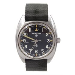  Hamilton British Military stainless steel manual wind wristwatch, back case issue markings ^ W10-6645-99 523-8290 5349/76, black dial Arabic numerals and outer luminous dot hand baton markers, on fabric strap
