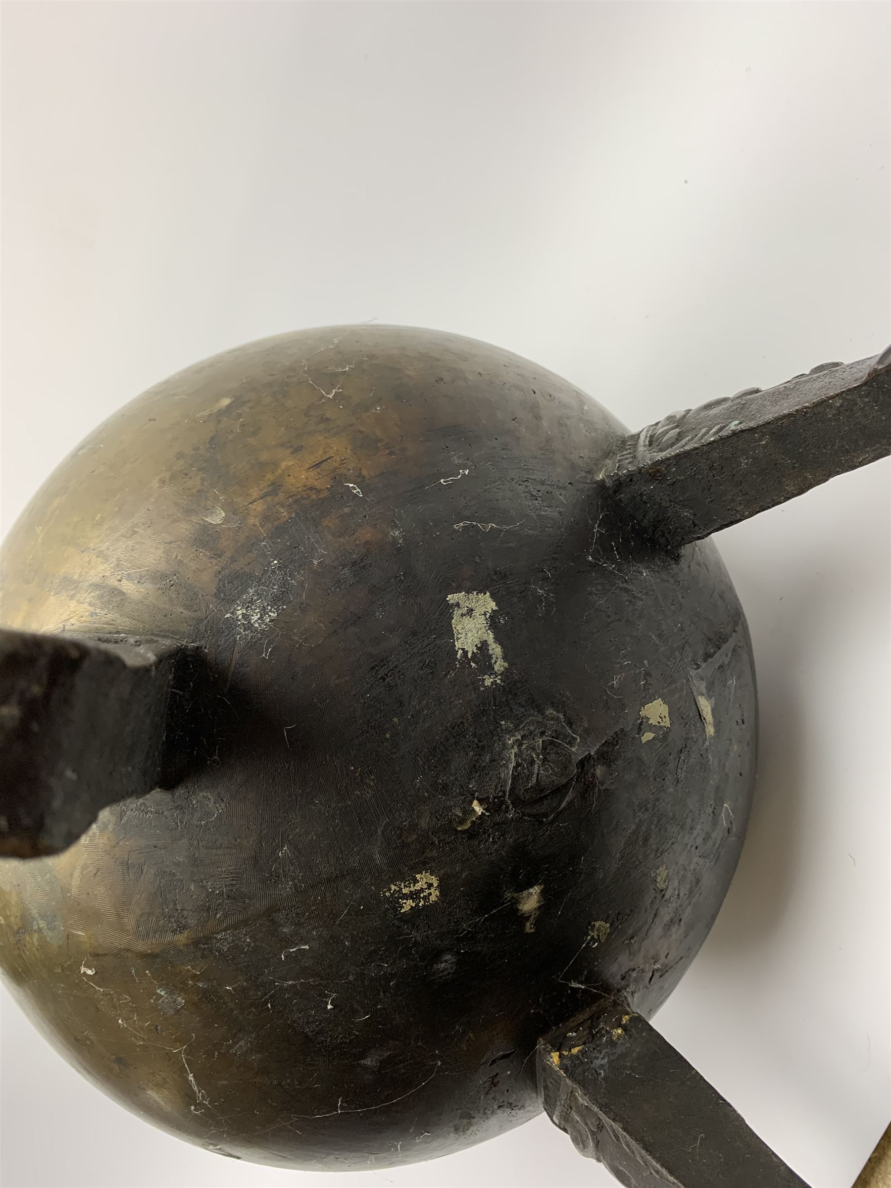 17th century bronze cauldron, probably German or Austrian, of bellied form with twin angular handles supporting a twisted handle, upon three splayed zoomorphic bearded mask feet, not including handle H30cm, rim D22cm