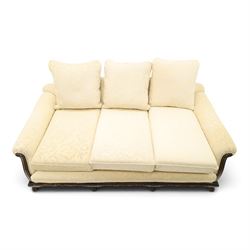Quality Edwardian carved mahogany lounge suite comprising three-seater settee and pair of armchairs, the sofa with arched back over rolled arms and deep sprung seat, the arm terminals carved with acanthus rosette over gadroon and rope-twist moulding, the shaped apron carved and moulded with scrolling foliate acanthus motifs, terminating to four large front hairy paw and ball feet, upholstered in pale yellow foliate fabric with matching seat and scatter cushions (W200cm D105cm H73cm); the matching deep armchairs (W78cm D95cm H75cm)