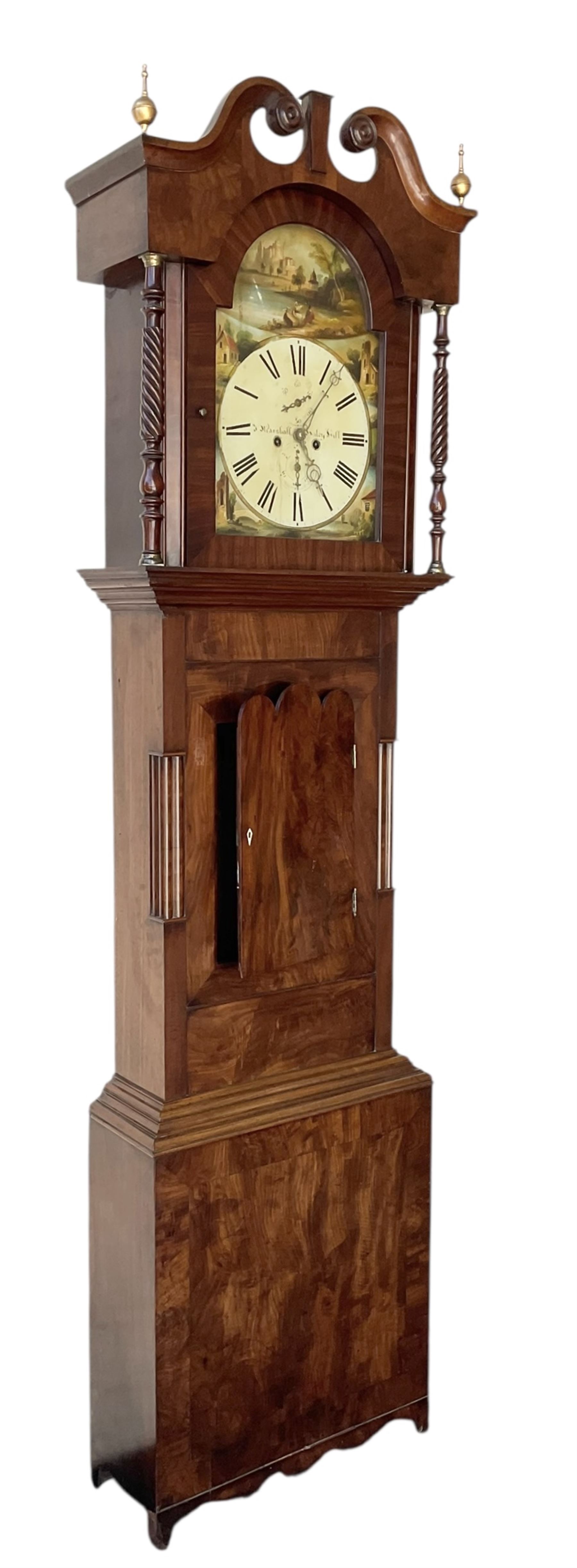 S Marshall of Saley Hill - late Victorian eight day mahogany longcase clock c1860, with a swan necked pediment and brass spire finials, break arch hood door beneath flanked by ring turned pilasters, trunk with inset twin columns and a short three spire door, on a broad plinth with a shaped base, fully painted dial with depictions of cottages to the spandrels and a rural scene to the arch, with Roman numerals , brass hands, seconds and calendar dials, dial pinned directly to a rack striking movement, sounding the hours on a bell. With weights and pendulum.