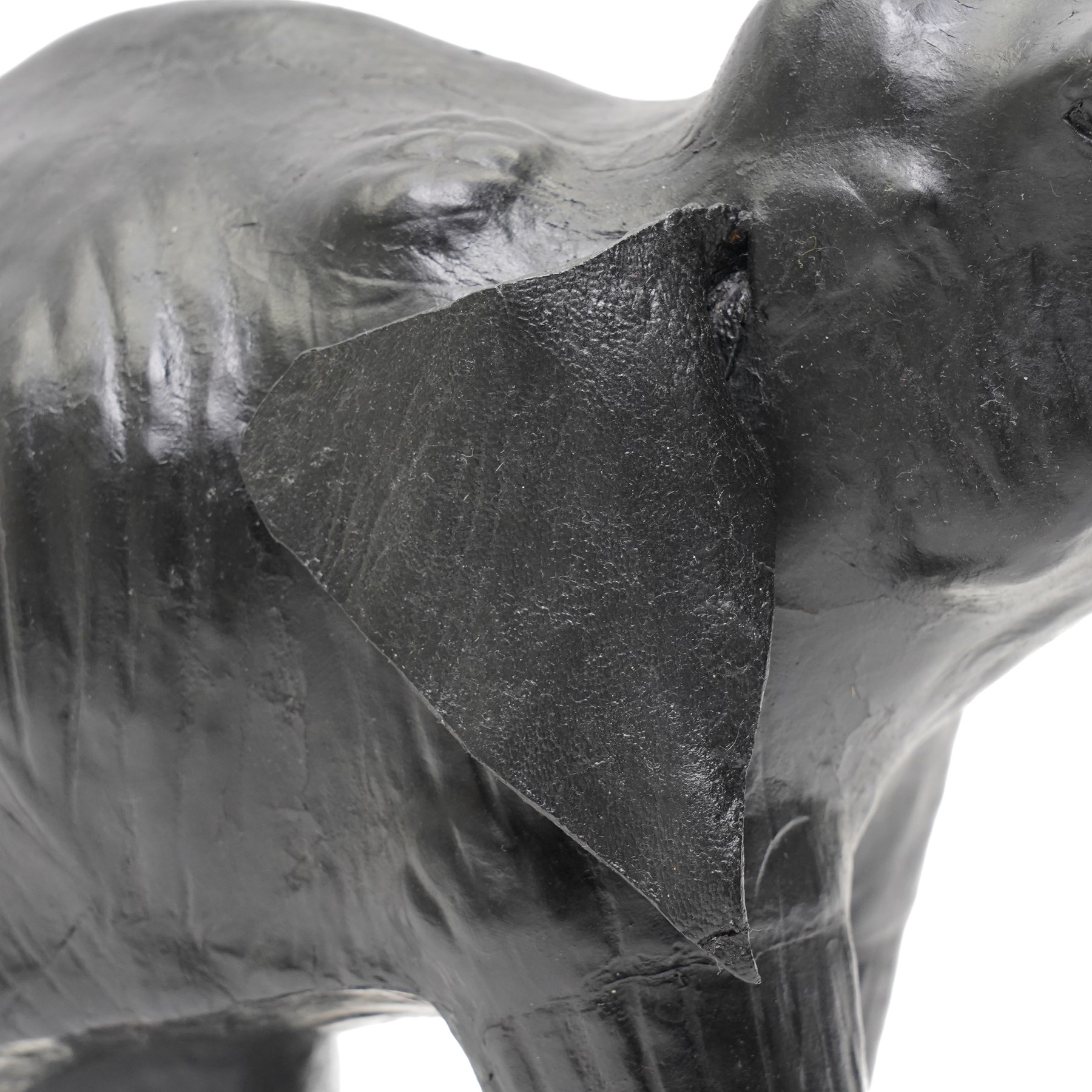 In the style of Liberty & Co - pair of 20th century ebonised papier mache elephants 