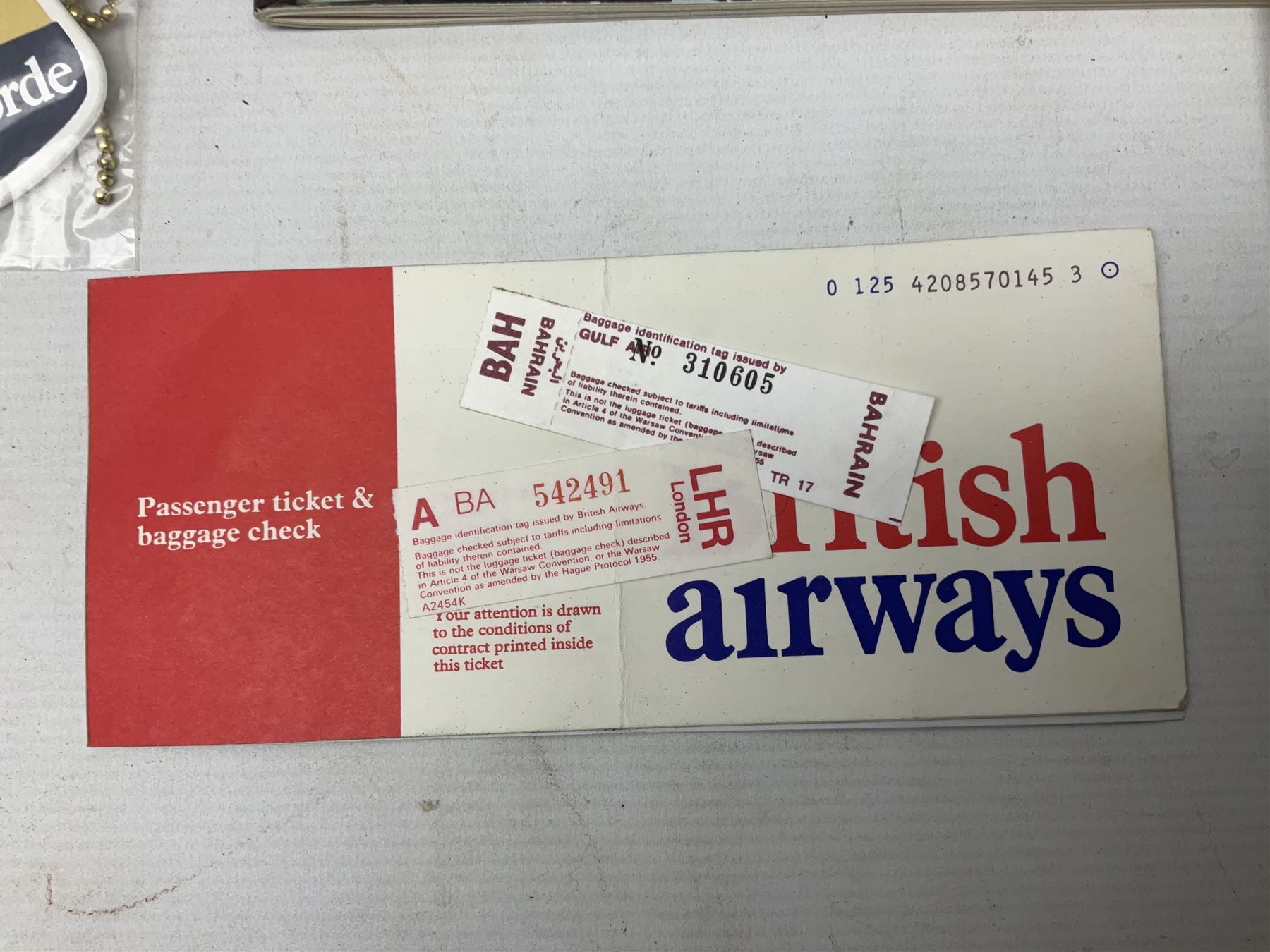 British Airways Concorde - inflight complimentary amenity pack including footwear, menu, stationery, three photographic slides, luggage label, cocktail stirrers, eye shades, fact sheet etc; in original branded blue vinyl bag with used 18th September 1977 ticket from Bahrain to London; together with a Singapore Airlines amenity kit bag with contents