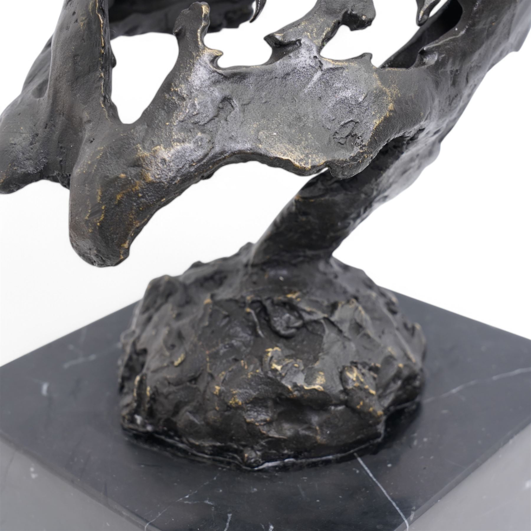 Bronze figure, modelled as a stylised horses head, upon a square marble plinth, signed and bearing foundry mark, overall H41cm