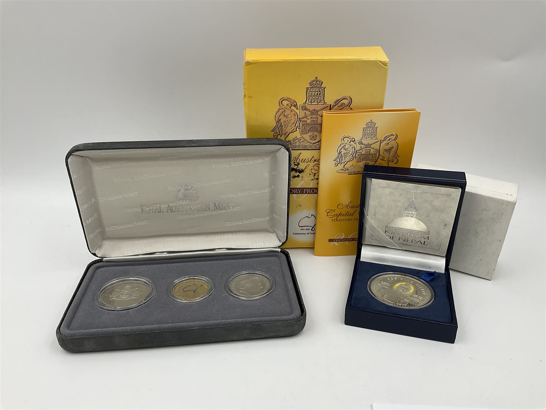 The Singapore Mint 2000 sterling silver proof one thousand five hundred Rs coin and an Australian Centenary of Federation 2001 three- coin set, both cased with certificates