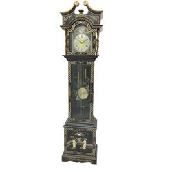 20th century 8-day chain driven black lacquered longcase clock - with a swans neck pediment and break-arch hood door, fully glazed trunk door displaying brass cased weights and pendulum, case sides, hood and plinth profusely decorated in gold relief and chinoiserie figures, brass break arch dial with an etched centre and silvered chapter ring, German two train movement striking the hours and half hours on two gong rods. With weights and pendulum.
