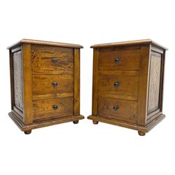 Pair of hardwood bedside chests, square tops with moulded edge, each fitted with three drawers flanked by square pilasters, raised on bun feet