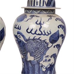 Pair of blue and white Chinese vase and cover, of baluster form, decorated with dragons, the cover with a fo dog finial, H15cm