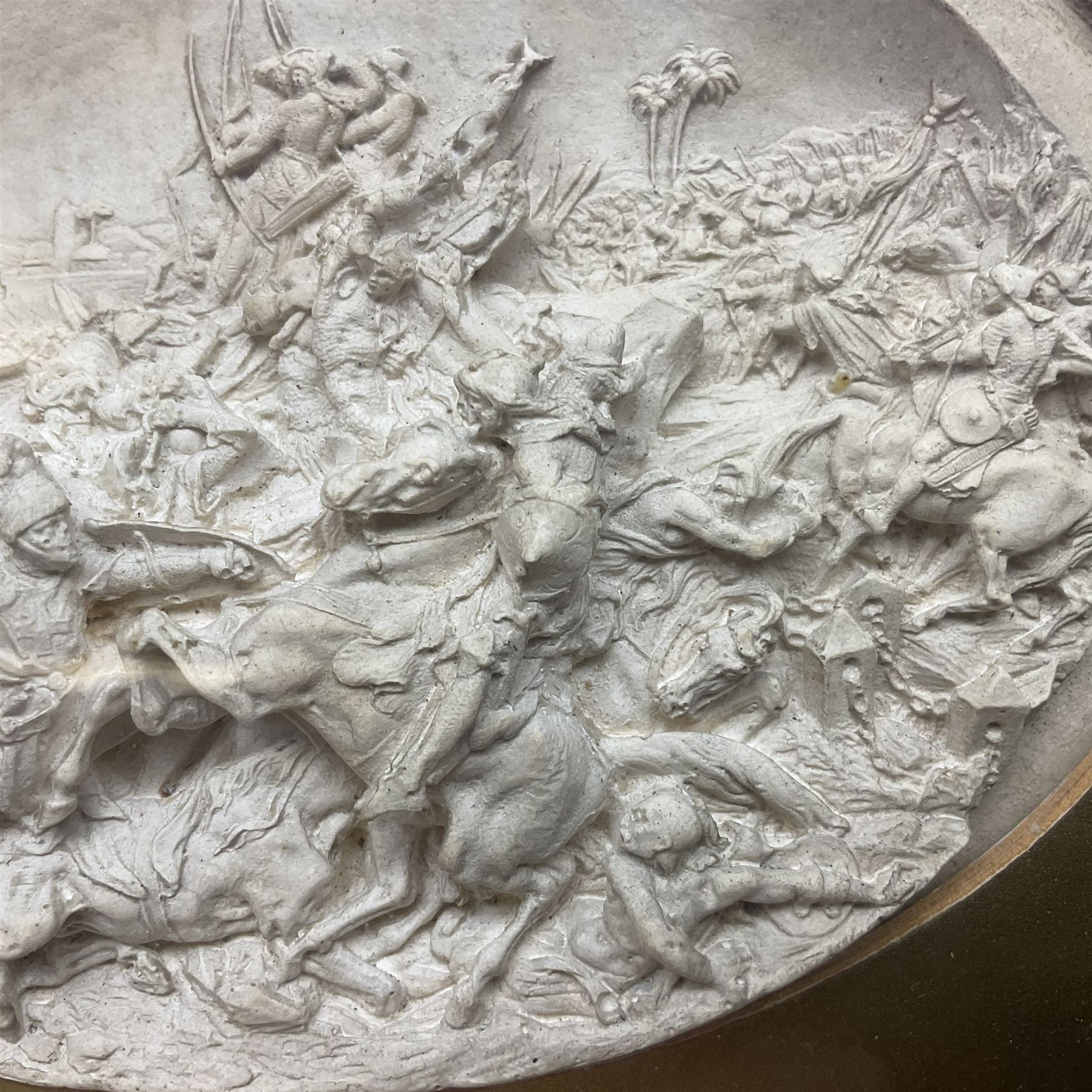 Justin Mathieu, two oval high relief plaque depicting a battle scenes, each within a wooden frame, frame  H21cm, L25cm