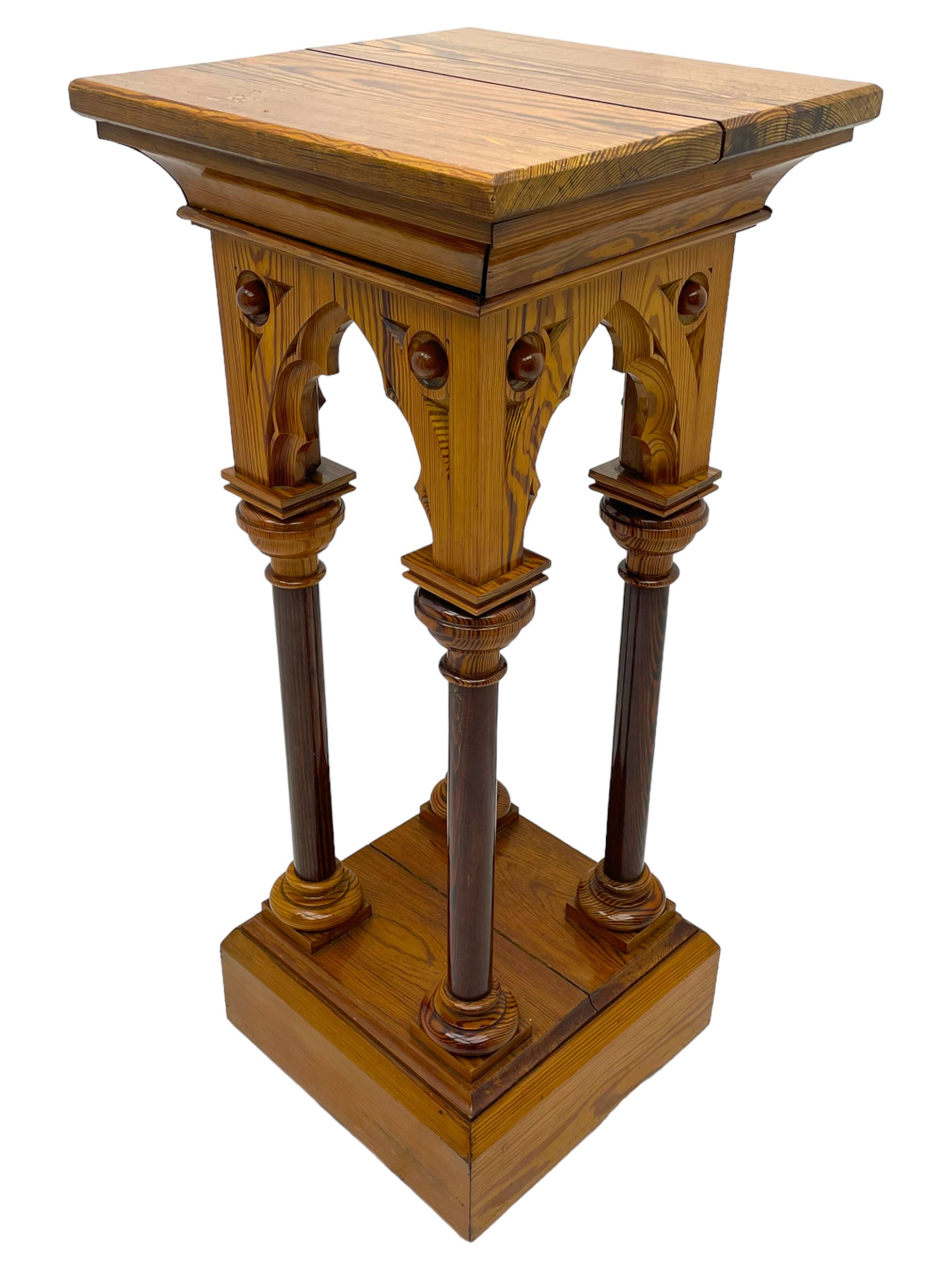 19th century pitch pine ecclesiastical pedestal stand, the square chamfered top over cusped Gothic pointed arches and four turned column supports, stepped and moulded plinth base