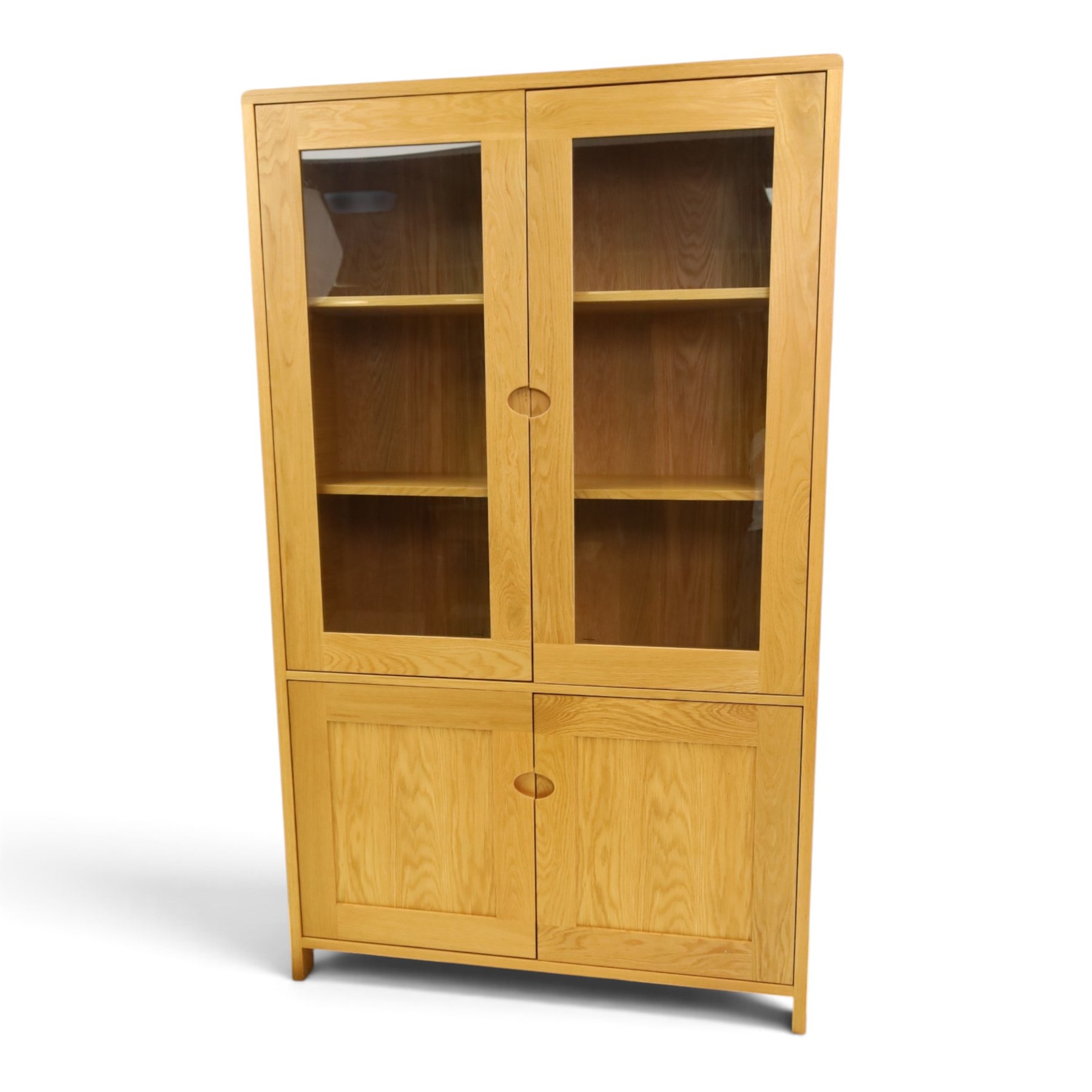 Ercol - contemporary oak 'Bosco' display cabinet, fitted with two shelves enclosed by glazed doors, over two cupboard doors, raised on stile feet