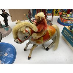 Mid 20th century and later tin plate clockwork toys, to include merry-go-rounds, spaceship carousel, walking robot, Schylling airport control tower, monkey riding horse, astronaut space station etc, including German and Japanese examples, some with boxes (12)