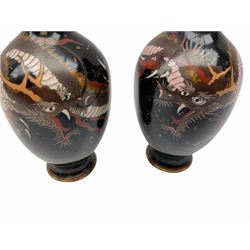 Pair of early 20th century Chinese cloisonné vases, of ovoid form with waisted necks, decorated with dragons upon a black and copper flecked flecked ground, H