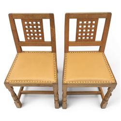 Mouseman - set of four oak lattice back chairs with tan seat with brass studded trim, with carved mouse signature, by the workshop of Robert Thompson of Kilburn