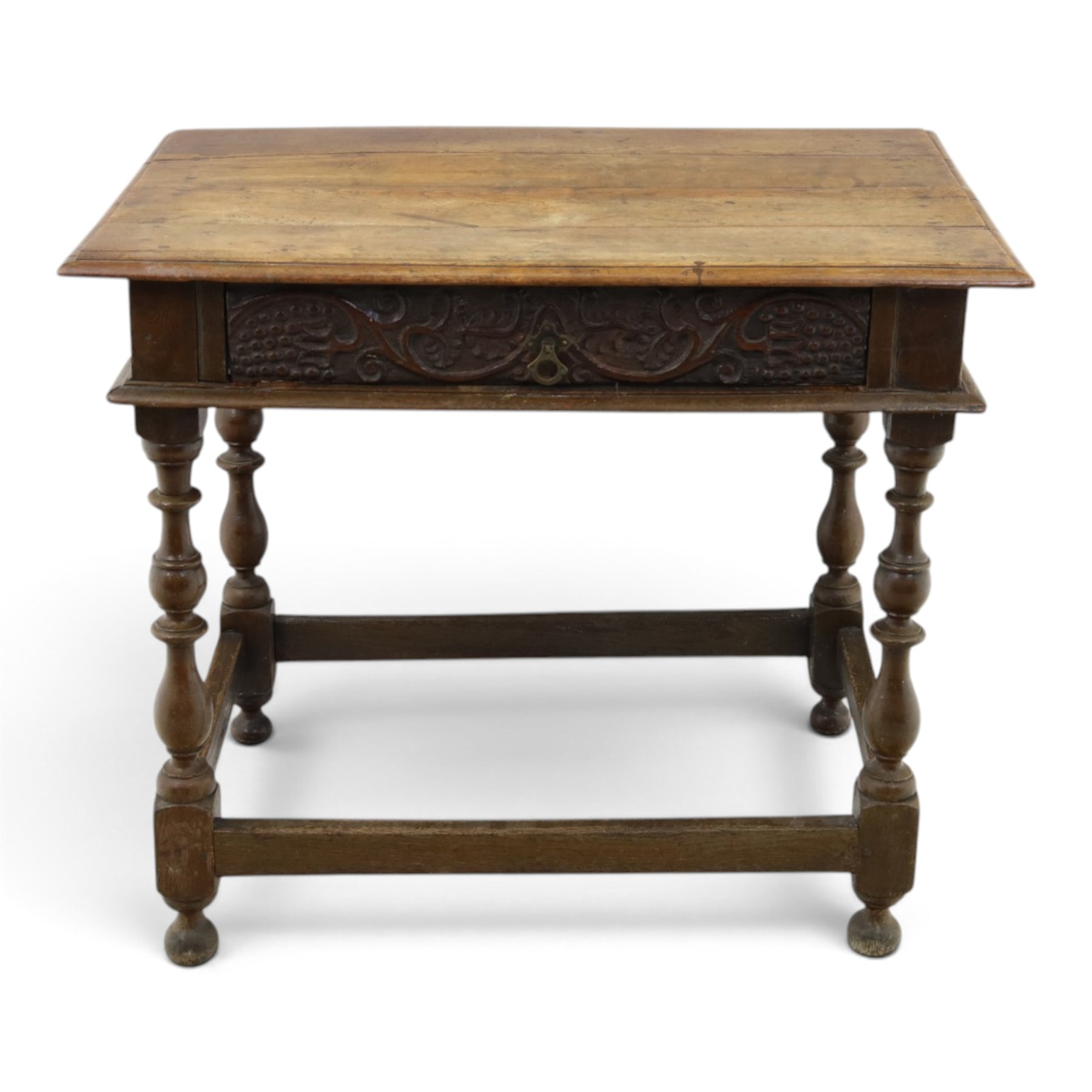 18th century oak lowboy, rectangular top with moulded edge, fitted with single frieze drawer carved with scrolling fruiting vines and stylised plant motifs, raised on bobbin-turned supports united by box stretcher 