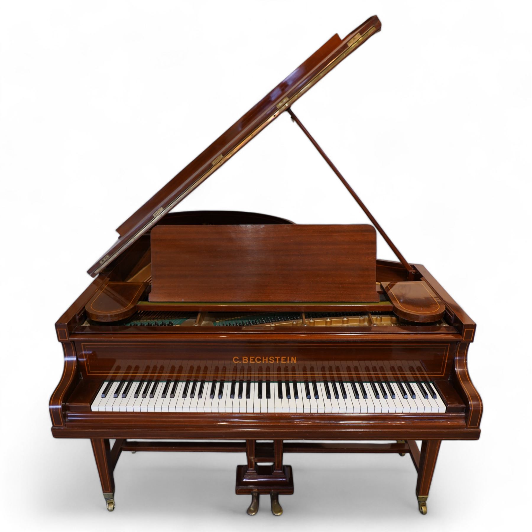 Carl Bechstein model A  grand piano serial No 44945 (1898), in a Sheraton revival mahogany case with inlaid satinwood stringing, overstrung cast iron frame raised on dual square tapering legs with brass castors, solid music desk and conforming lyre, 85 note (7 octave) A-A compass, sostenuto and sustain pedals, original action, hammers, dampers and stringing.

This item has been registered for sale under Section 10 of the APHA Ivory Act