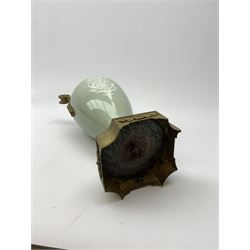 A pate sur pate celadon green vase, of baluster form decorated with a classical female figure to one side, and floral swag with ribbon and musical trophy to the other, with twin gilded scroll handles, and raised upon a gilded base, overall H38.5cm. 