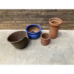 Cast iron cauldron set pot with 2 terracotta chimney pots and 2 terracotta planters,