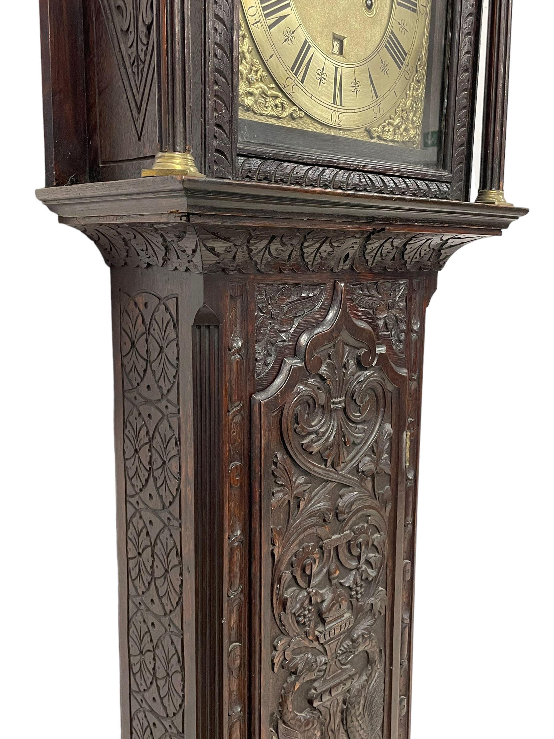 18th-century profusely carved oak longcase clock - with a pagoda pediment, upstands and carving, 
 break arch hood door flanked by reeded pilasters with brass capitals, trunk with canted corners and a spire topped door, square plinth with applied skirting, break arch brass dial with wheatsheaf engraving and cast cherub and crown spandrels, engraved break arch with the London clockmakers name John Gordin, silvered chapter ring with Roman numerals, five minute Arabic's, minute and quarter hour tracks, matted dial centre with ringed winding holes, square date aperture and seconds ring, dial pinned to a five pillar movement with inside countwheel striking, striking the hours on a cast bell. With weights and pendulum. John Gordin, is possibly a mis-spelling or phonetic spelling of John Gordon, of London, who worked from Ludgate Street in the parish of St. Gregory by St. Pauls. Apprenticed in 1689 and died in 1732 when his will was proven.

