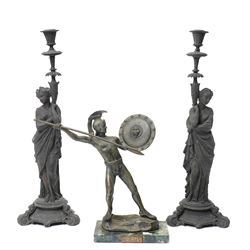 Pair of late 19th century spelter candlesticks in the form of classical figures on circula...
