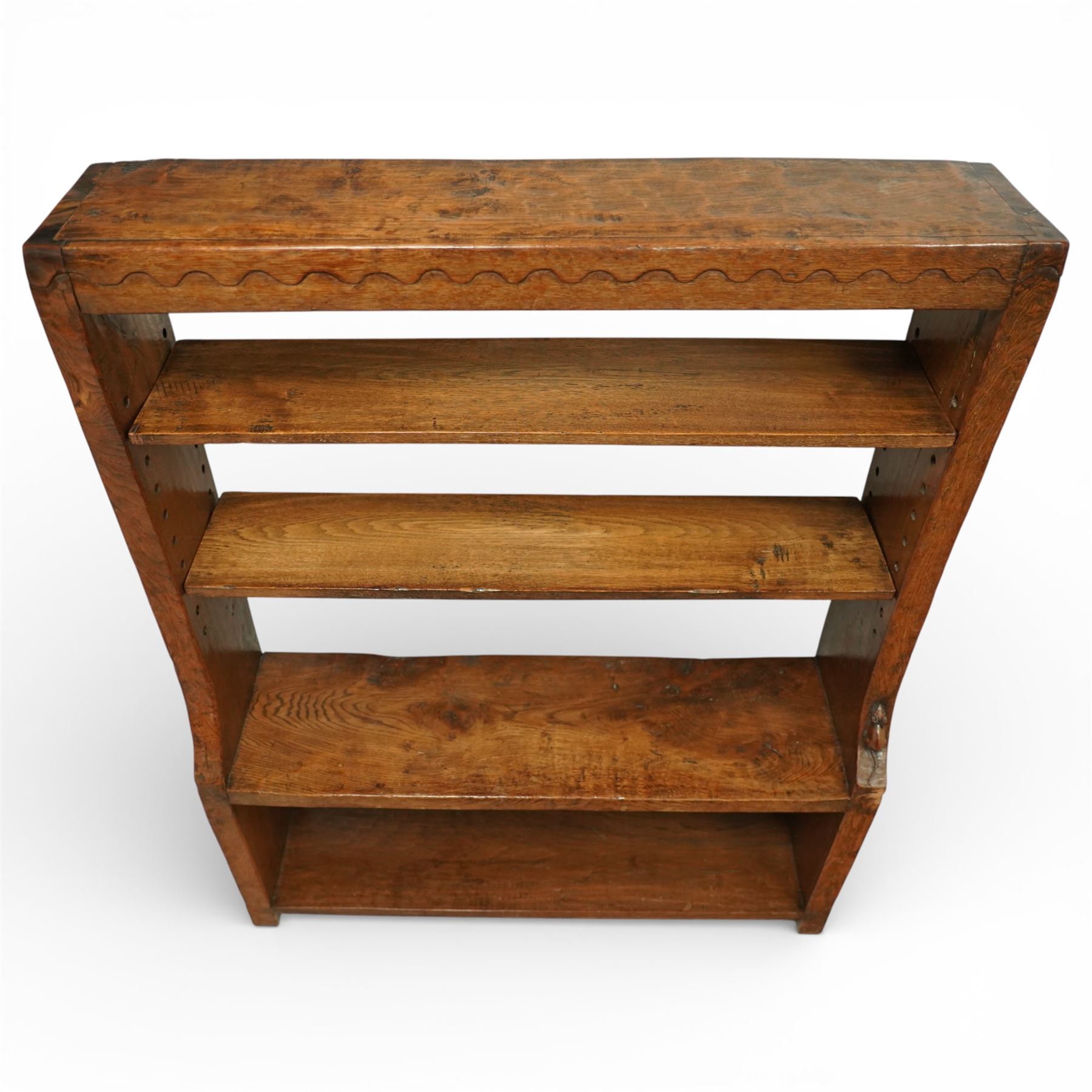 Mouseman - circa 1920s/1930s oak open back 3ft bookcase, the adzed top with scalloped detail, dual depth adzed ends, with two adjustable shelves over two fixed shelves, with carved fat mouse signature, by Robert Thompson of Kilburn