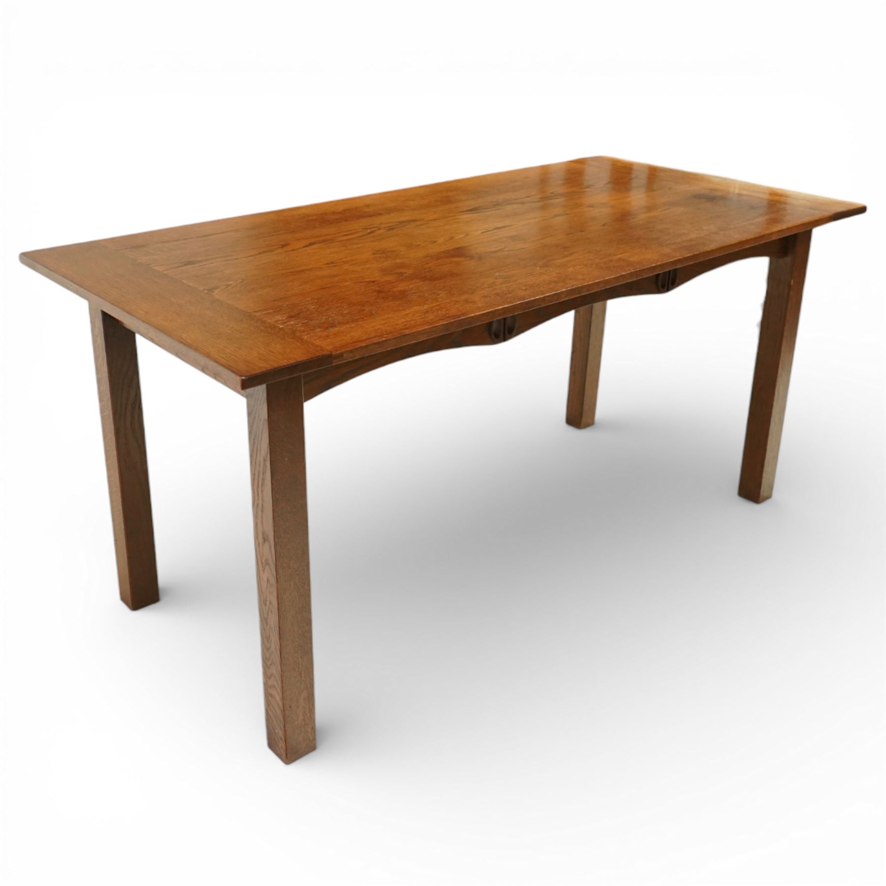 Late 20th century Mackintosh style oak dining table, rectangular top with broad plank surface over shaped frieze with twin pierced oval apertures, raised on square section supports