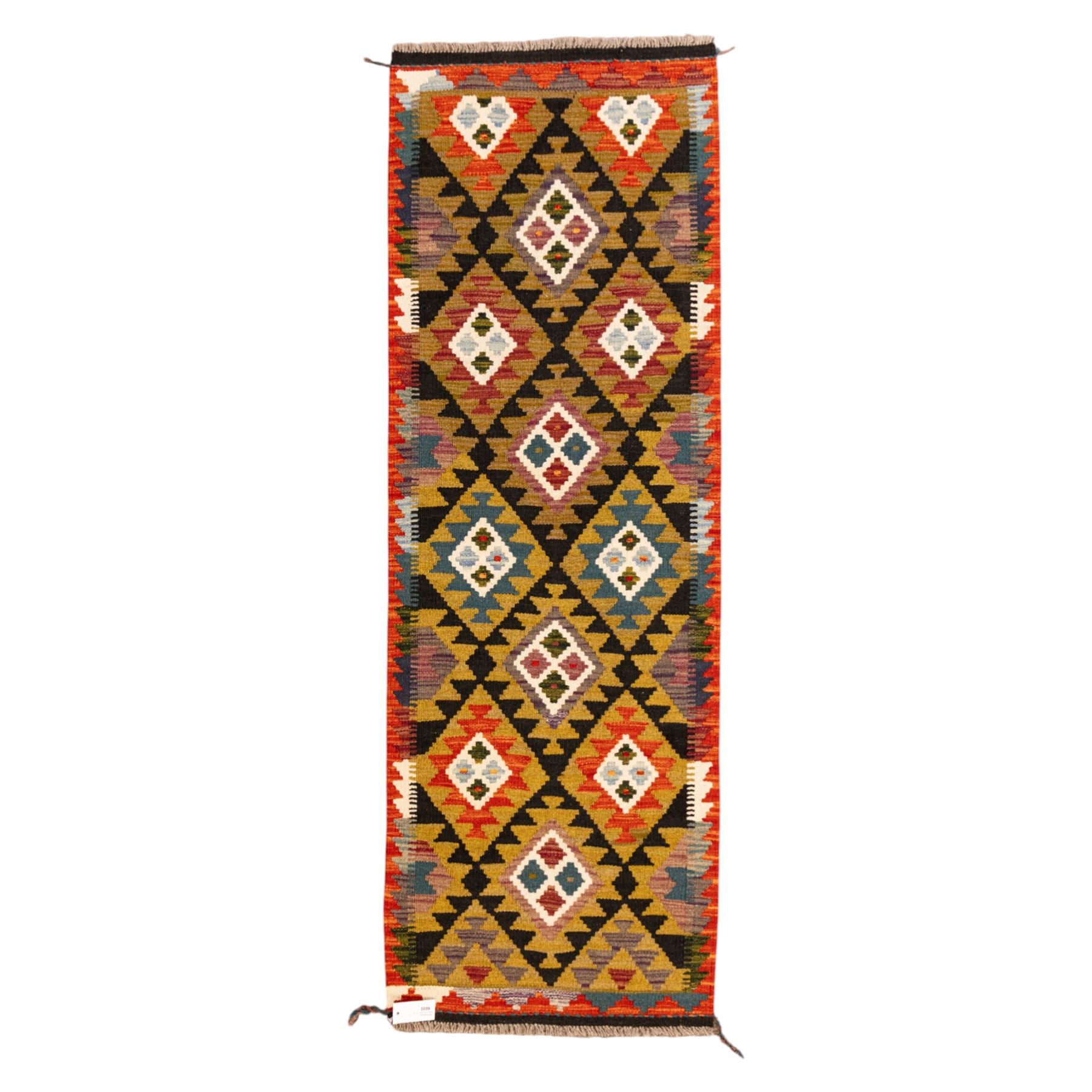 Afghan Maimana flatweave kilim runner, central field features large bold nested diamond motifs and stylized geometric lozenge patterns on olive purple, blue, and green tone ground, border stripe in orange ground, and fringe