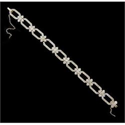 18ct white gold and platinum, milgrain set old cut diamond flower head and openwork panel link bracelet, total diamond weight approx 4.25 carat