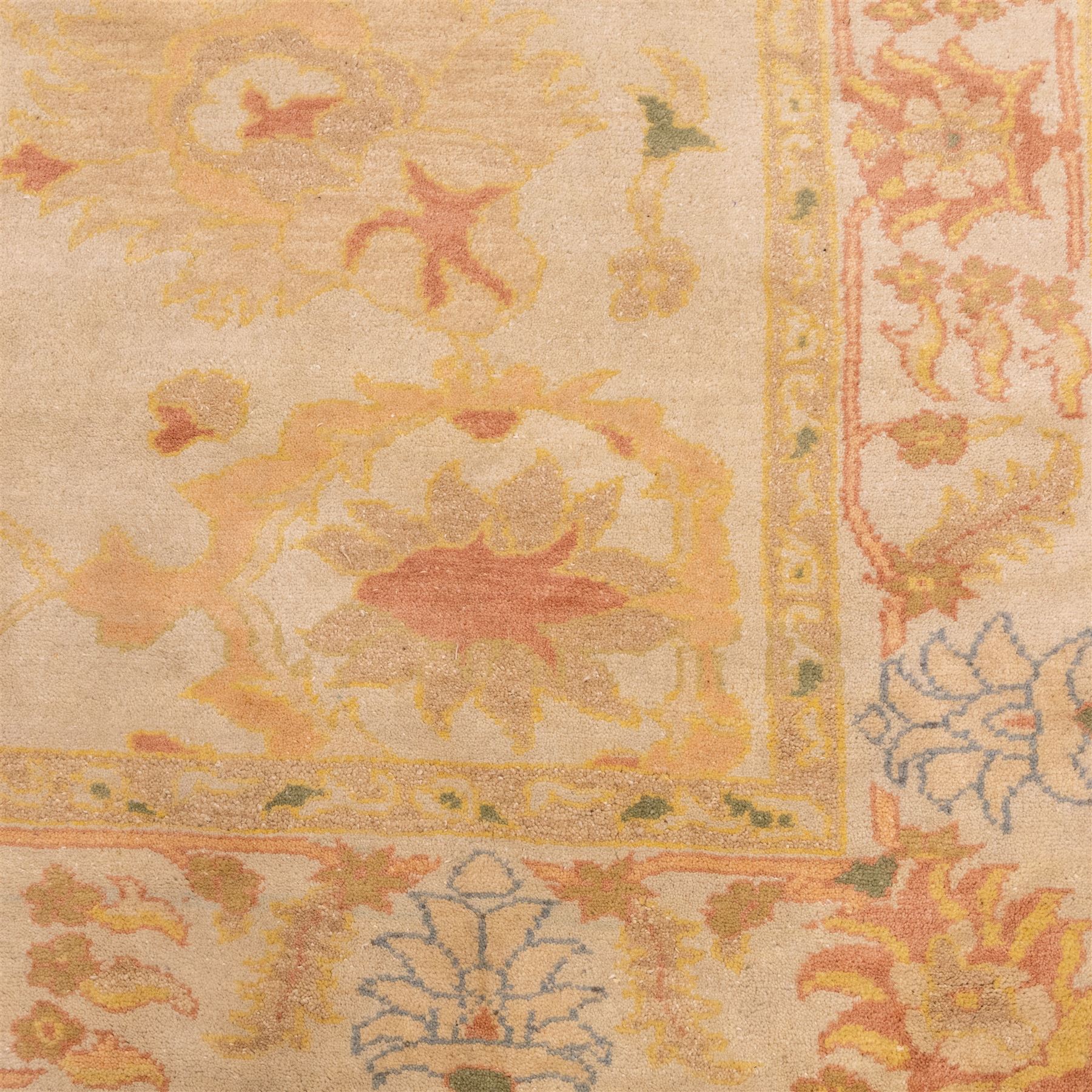West Persian hand-knotted Ziegler design rug, ivory field decorated with an all-over lattice of stylized palmettes and floral sprays linked by angular vines, border of scrolling floral ornamentation in a palette of blush pink, sage green, powder blue, and soft ochre, with cotton fringe ends 
