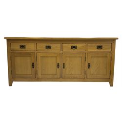 Light oak sideboard, fitted with four drawers and four panelled cupboards