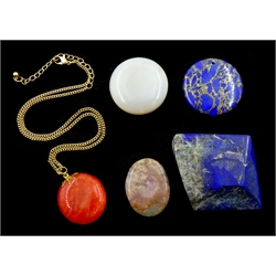 Lapis lazuli, jade and stone pendants and a piece of polished lapis lazuli stone