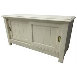 Cream finish low side cabinet, moulded rectangular top over two sliding panelled doors, on stile supports 