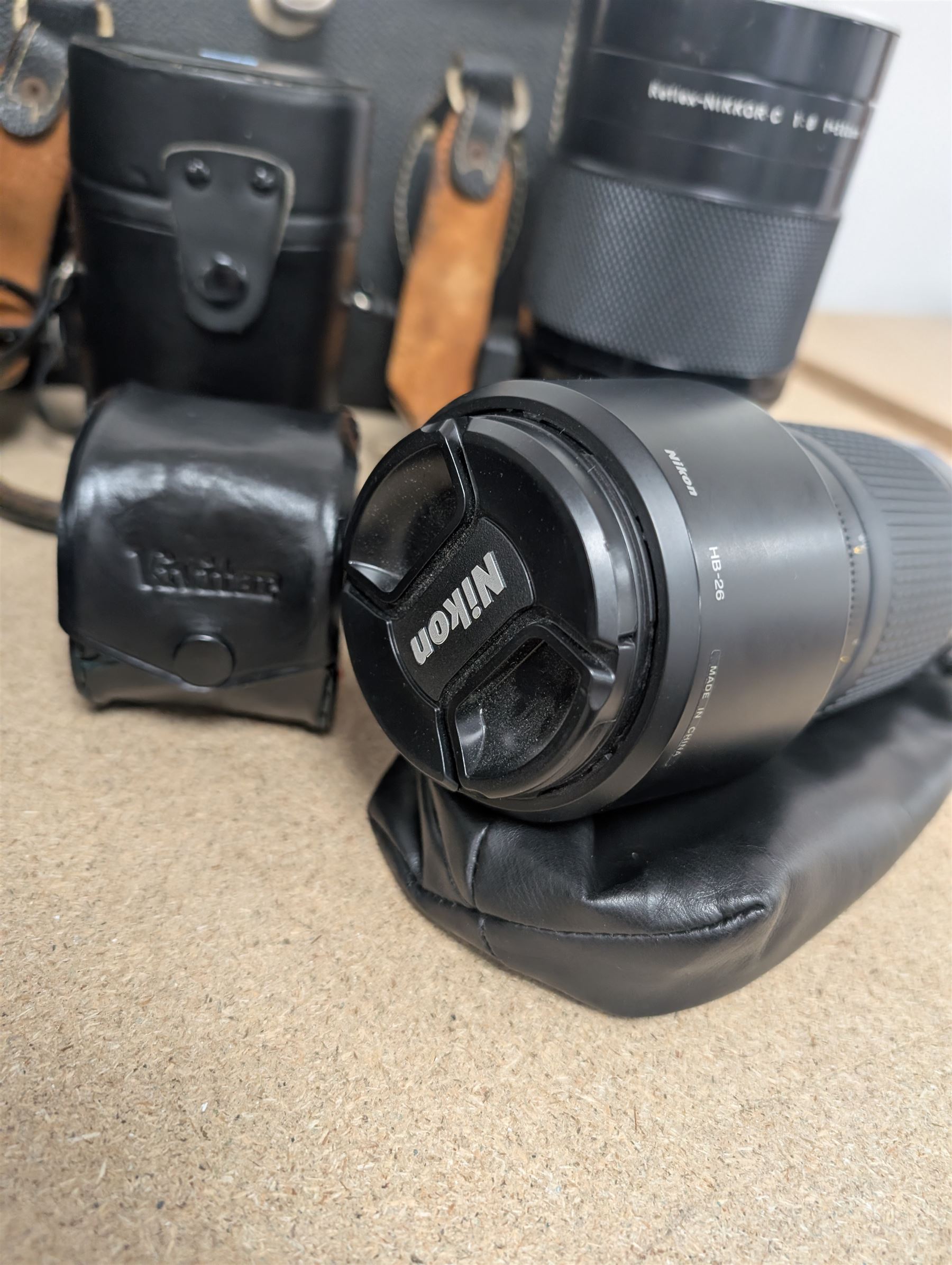 Kodak Dakon II folding camera and a collection of camera lenses and accessories, including Reflex-Nikkor  1:8 f=500mm, NikoN AF Nikkor 70-300mm 1:4-5.6G, Micro TM monocular lens and Teleshot adapter, two cases, Weston exposure meter, two cases etc