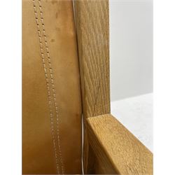 'Mouseman' oak smokers armchair, panelled sides, slung tan leather back and upholstered seat cushion, by Robert Thompson of Kilburn