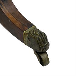 Regency rosewood and brass inlaid card table, the rectangular fold-over and swivelling top with rounded corners with a satinwood band, opening to reveal a blue baize lined interior playing surface, the frieze with a raised panel with satinwood stringing and a lower beaded brass edge, the concave and canted column with a shaped platform base applied with scrolls with brass star inlays and stringing, quadruple splayed supports terminating in foliate cast cups and castors