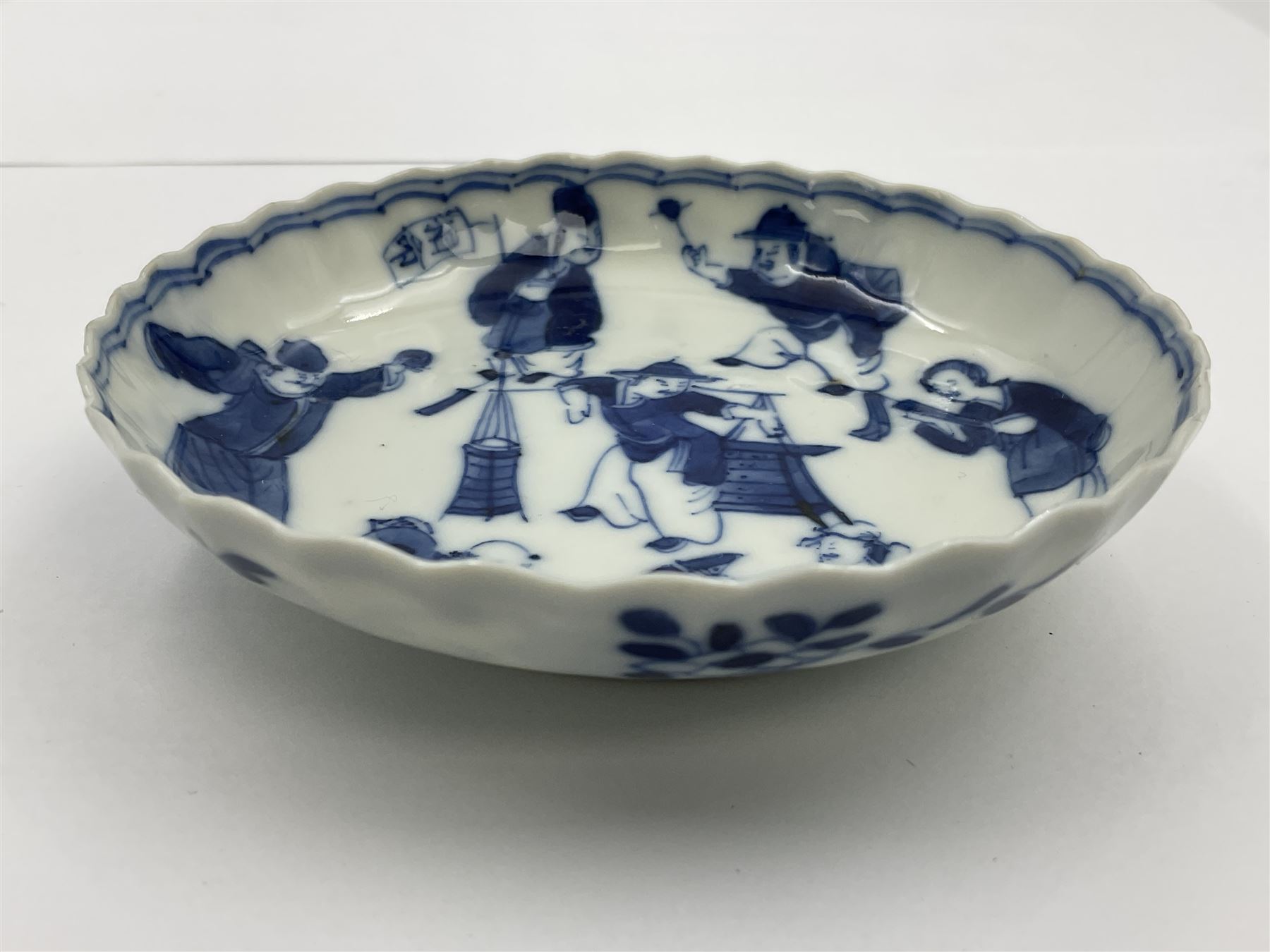18th century Chinese blue and white Kangxi teacup and saucer, decorated with dancing figures, four character Kangxi mark beneath, saucer D10cm