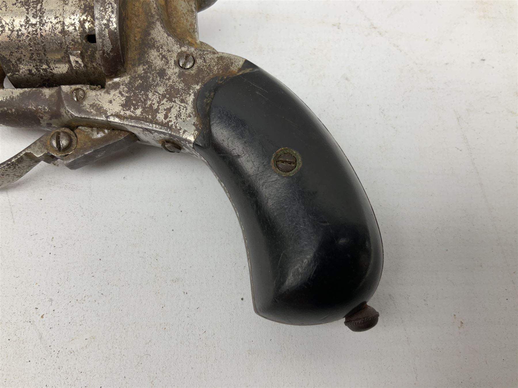 19th century 7mm six-shot pin-fire revolver, with folding trigger, two-piece ebonised grip and ejector rod in butt L17cm