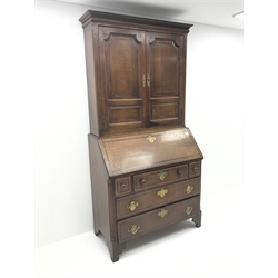 Georgian oak and mahogany bureau bookcase, projecting cornice, dentil frieze, two cupboard doors, fall front enclosing well fitted interior above five drawers, W108cm, H210cm, D52cm