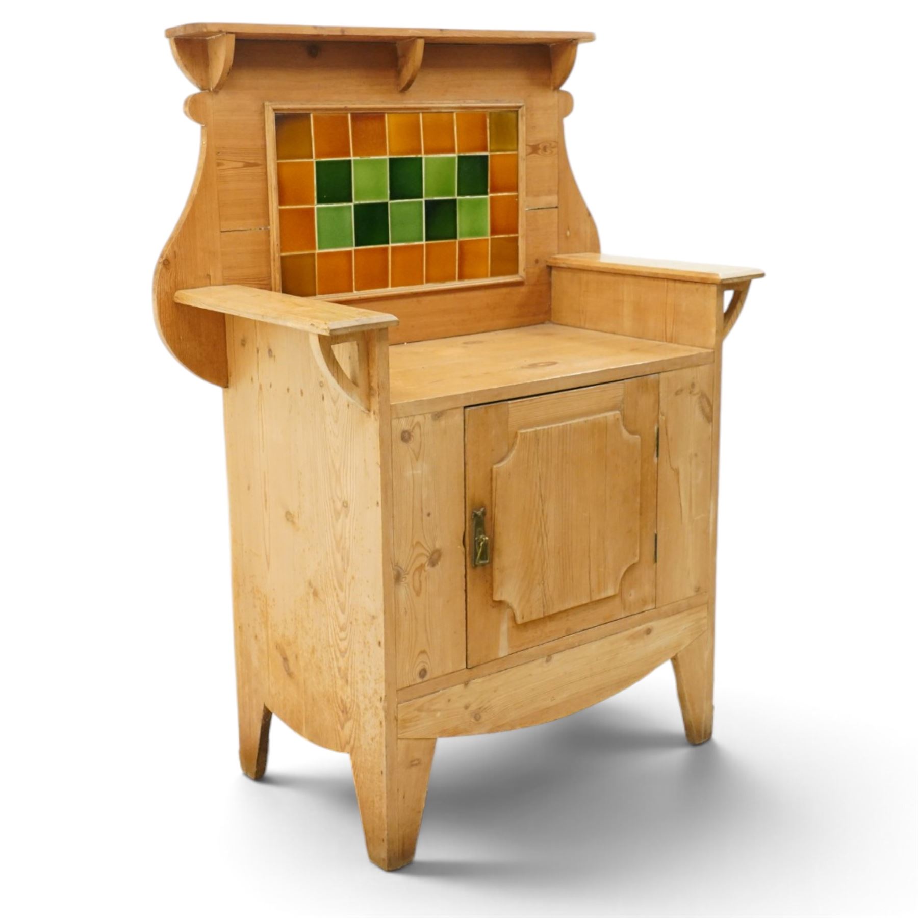Arts & Crafts pine kitchen cabinet, raised tiled back with projecting shelf and shaped side supports, rectangular work surface above single cupboard door with moulded panel, on square supports