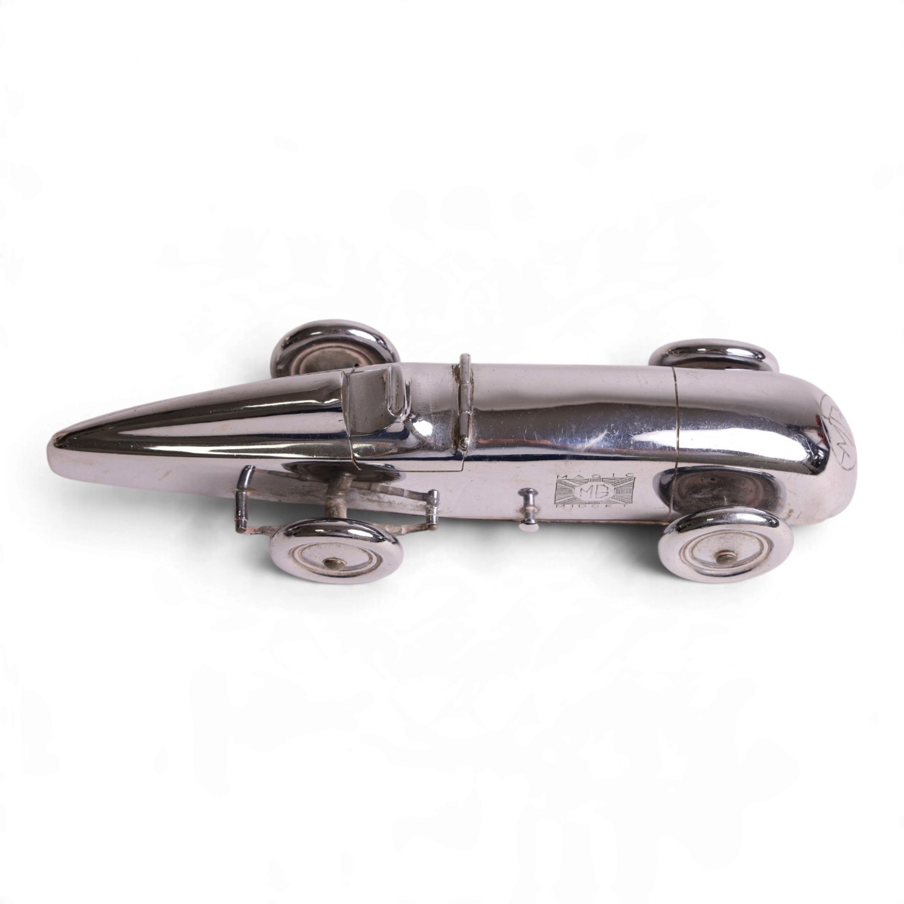 MG Magic Midget table lighter, circa 1933, chrome plated, engraved to the nose and on one side, marked beneath 'S&M, Made in England, Pat. no. 373219' 