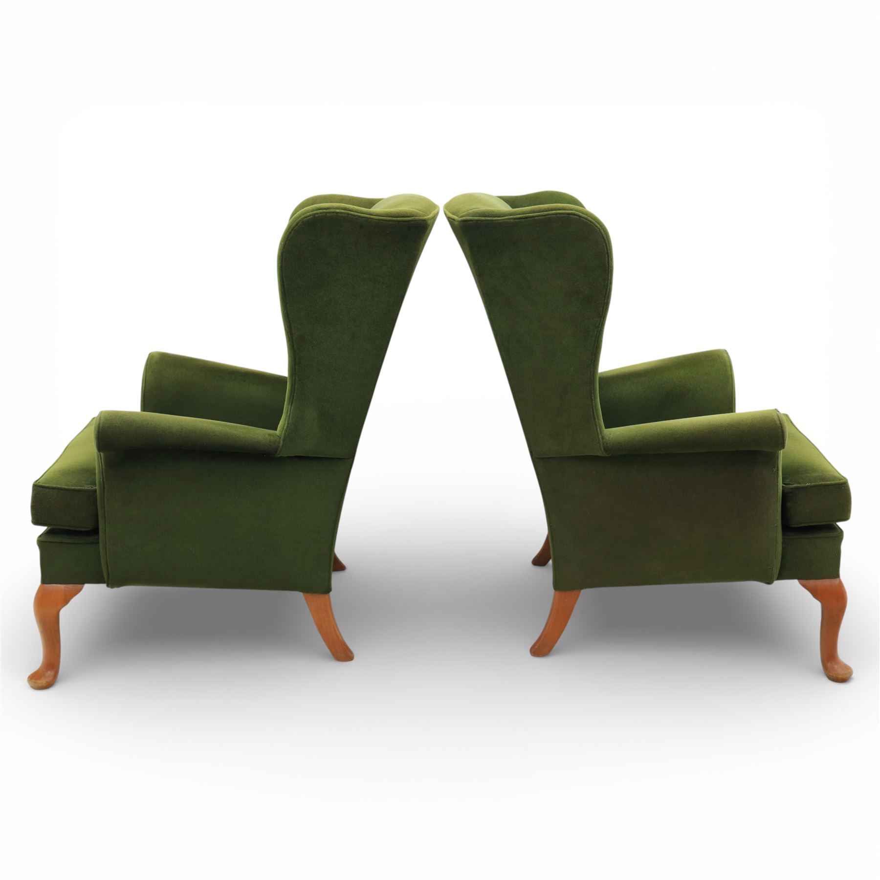Parker Knoll - pair of 'Penhurst' wingback armchairs upholstered in olive green fabric, on light stained supports 