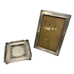 Edwardian silver stand, of square shaped form, upon four bun feet, hallmarked Birmingham 1907, together with an early 20th century silver mounted photograph frame, hallmarked Birmingham 1918, approximate weighable silver 93.6 grams
