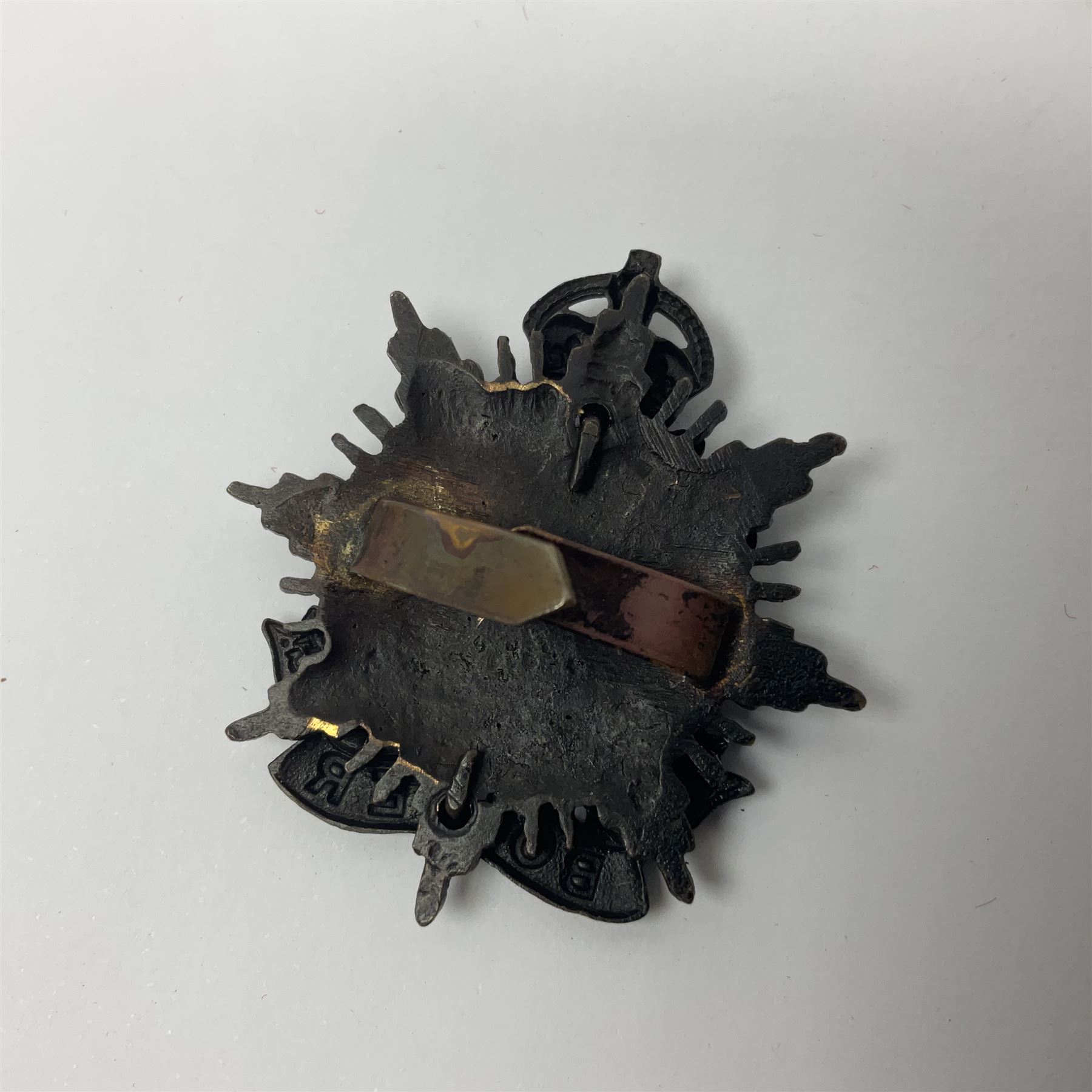 Four Border Regiment cap badges including eleventh battalion (4)