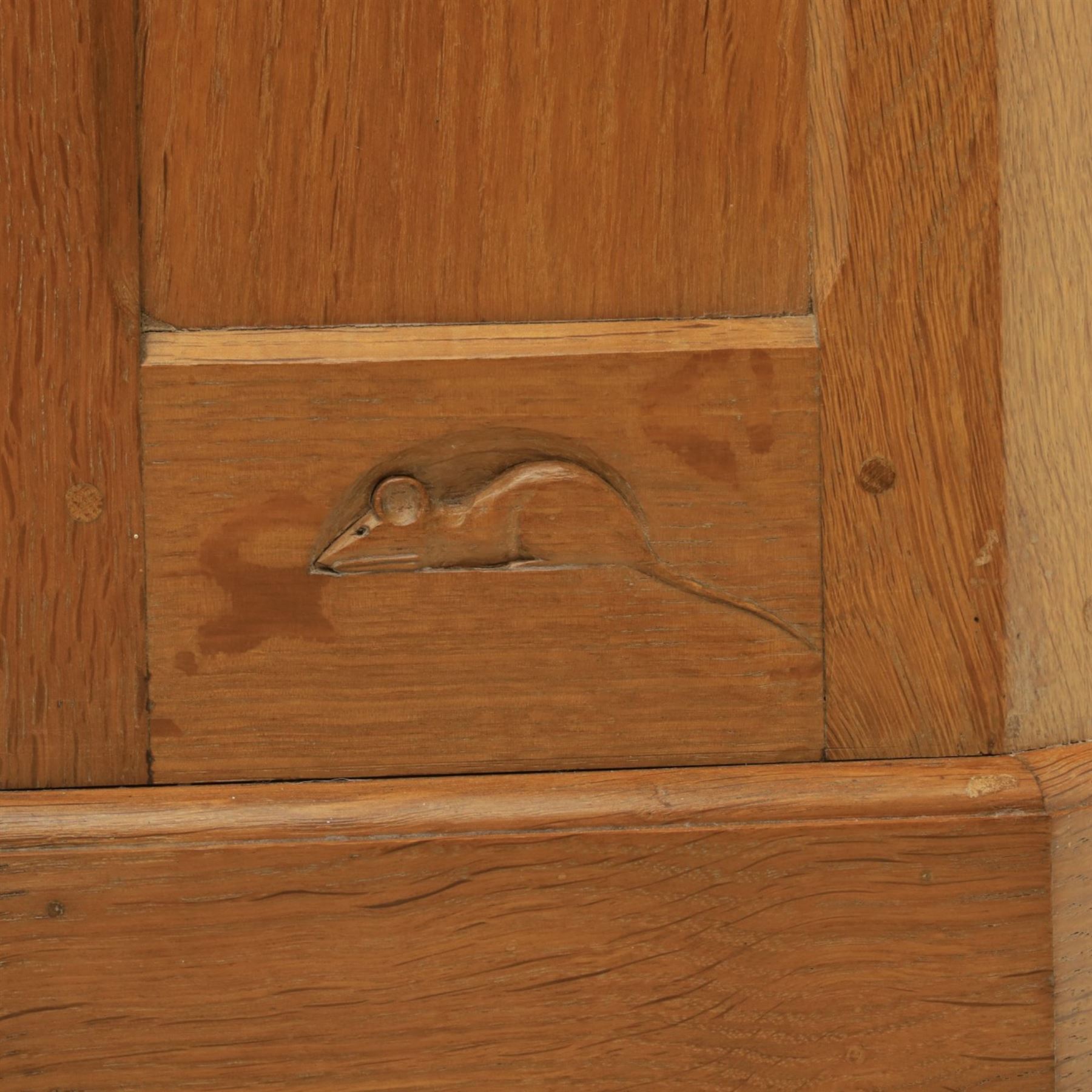 Mouseman - oak floor standing corner cabinet, scalloped cornice above a leaded glass cabinet, blackened metal hinges and latches, with carved mouse by the workshop of Robert Thompson of Kilburn