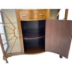 Mid-20th century Art Deco style walnut display cabinet, two central drawers over cupboard flanked by two bevel glazed display cabinets with sunburst astragal glazing, on ball and claw cabriole feet