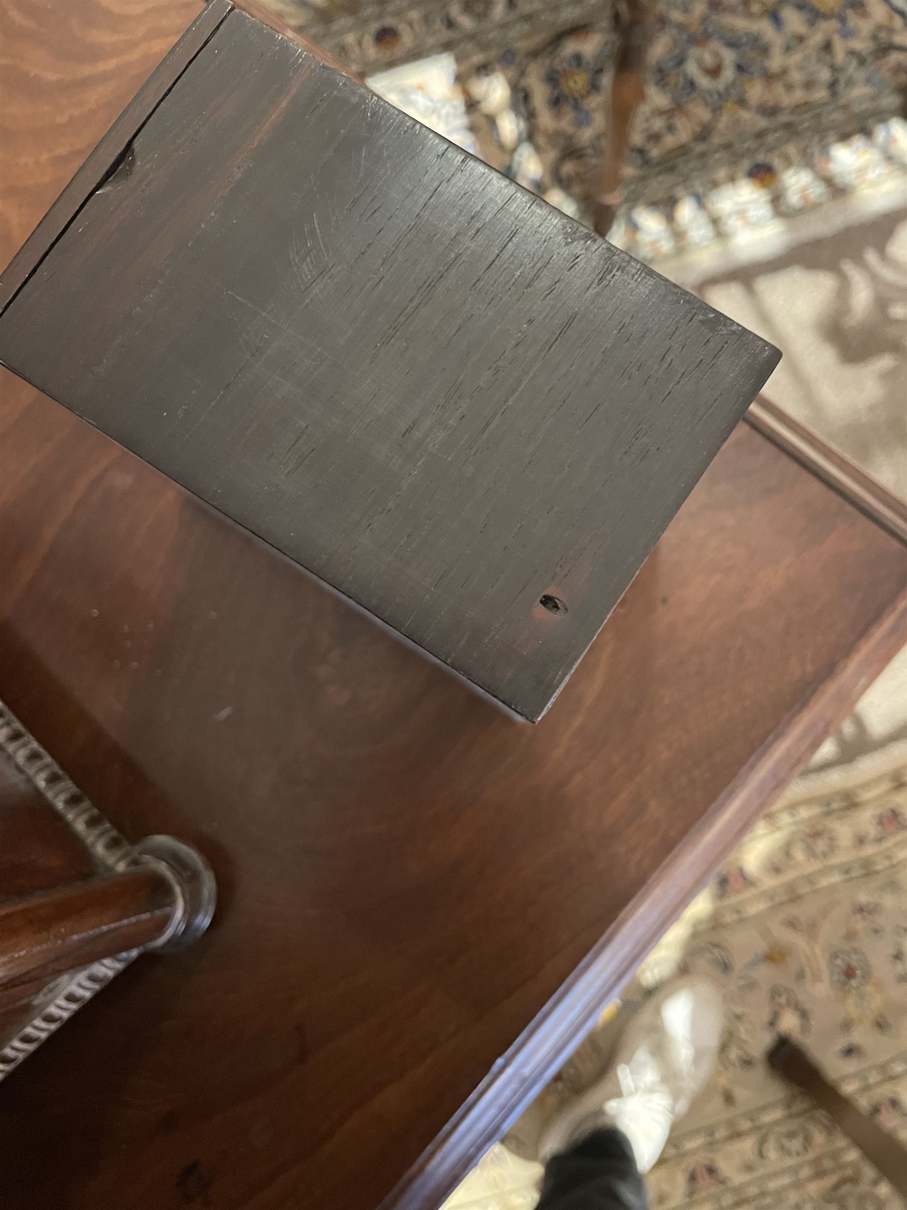 Early 19th century rosewood and brass inlaid tea caddy, of sarcophagus form, the front and hinged opening cover inlaid with brass scrolling panels, opening to reveal a compartmented interior with twin removable boxes with conforming inlaid brass detail to the hinged covers and zinc lining to the interiors, flanking a later glass mixing bowl, the whole upon four turned cylindrical feet, H21cm W36cm D20cm