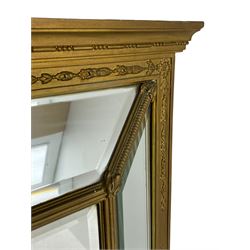 19th century giltwood and gesso cushion framed mirror, the frame decorated with trailing flower heads, fitted with fan and scroll decorated brackets, bevelled glass plates