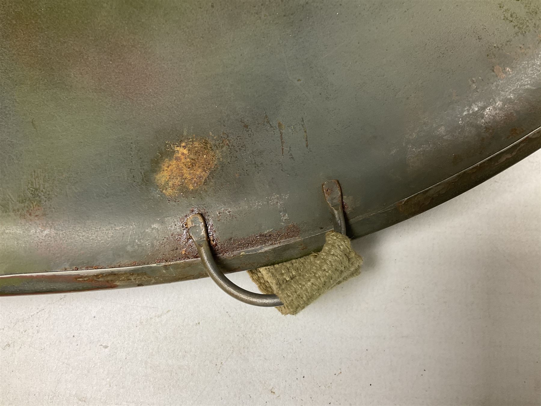 American first type paratrooper helmet with post-WW2 strap and D-rings and later 1944 liner bearing Firestone Tyre and Rubber Company mark; green textured finish